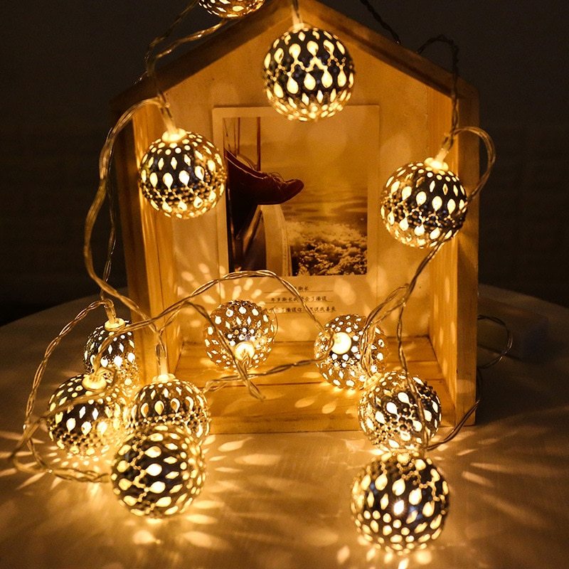 VibeCore Moroccan Orbs String Lights, featuring a mix of silver and gold orbs, add a warm, charming glow to any space. Perfect for bedrooms, dorms, or apartments, these battery-powered LED lights are portable and stylish.