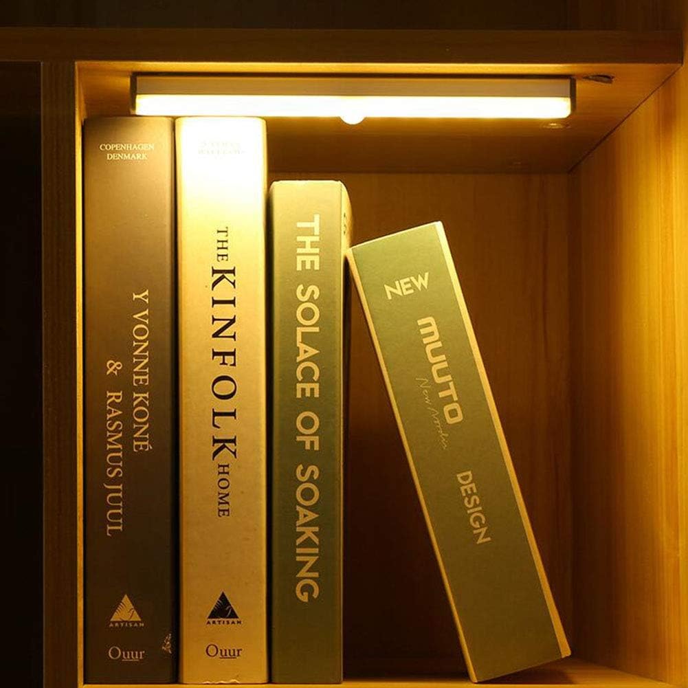 VibeCore Motion Sensor LED Light Bar placed on top of a bookshelf, showcasing its sleek design and efficient, motion-activated lighting. This easy-to-install light bar adds convenience and energy-efficient illumination to any space, perfect for shelves, hallways, or closets.