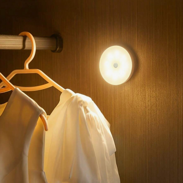 VibeCore Motion Sensor Puck Light in Warm White installed in a closet - Modern motion-activated LED light with PIR sensor, 9.8 ft range, USB rechargeable battery, and versatile installation for convenient closet lighting.