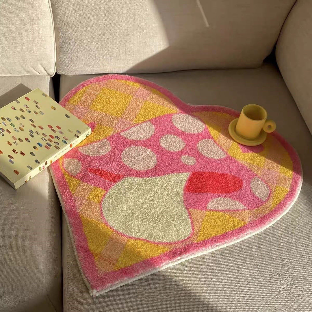 VibeCore Mushroom Heart Accent Rug placed on a couch, featuring its playful mushroom and heart design, soft texture, and vibrant colors, adding a cozy and whimsical touch to the room.