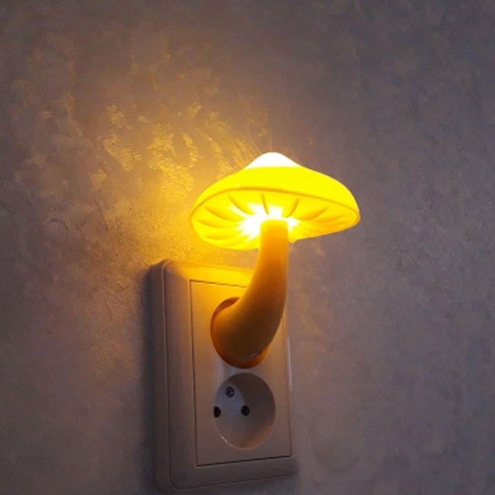 VibeCore Mushroom Night Light in yellow, plugged in, viewed from another angle. The light emits a soft, warm glow, perfect for creating a cozy atmosphere while conserving energy.