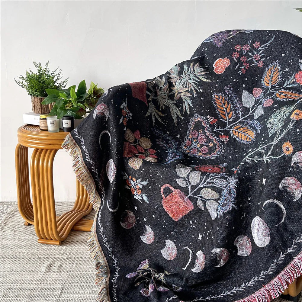 VibeCore Mystic Bloom Woven Blanket draped over a chair, showcasing its mystical floral design in vibrant colors, made from soft, breathable 100% combed cotton, perfect for adding an enchanting touch to your space.