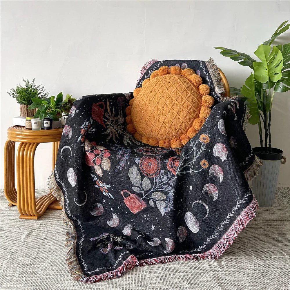 VibeCore Mystic Bloom Woven Blanket on a chair, showcasing its mystical floral pattern and soft 100% combed cotton material, adding a touch of nature-inspired elegance to the space.