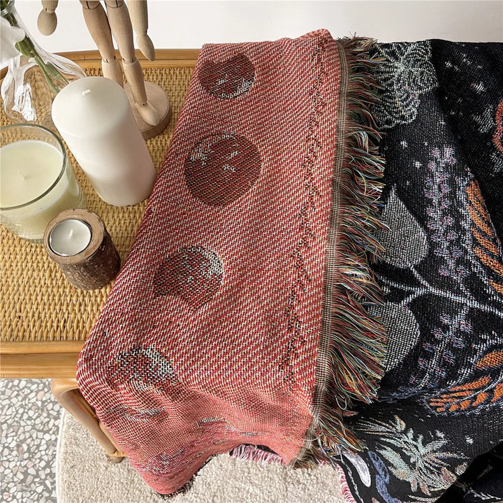 Close-up of the VibeCore Mystic Bloom Woven Blanket showing its reversible design with two distinct, vibrant floral patterns.