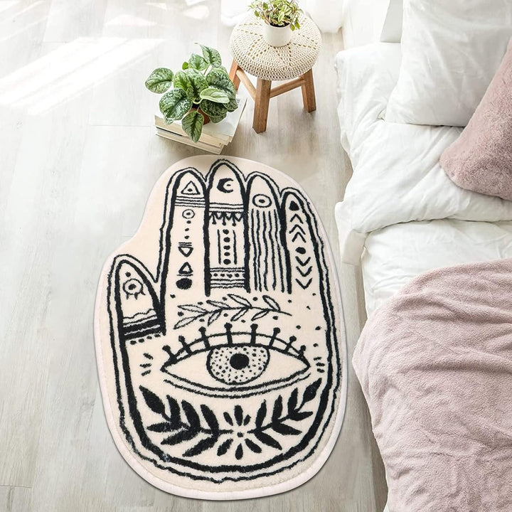 VibeCore Palmistry Accent Rug beside a bed, featuring a detailed palm print design on a soft, plush fabric that adds a mystical, esoteric charm to the room's boho aesthetic.