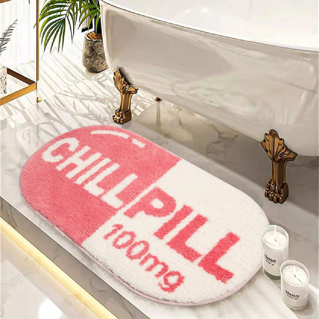 VibeCore Pink Chill Pill Accent Rug as a bath mat, showcasing its soft, water-absorbent texture in a cute Nordic-style oval design. Perfect for adding a playful, quirky vibe to any bathroom, this fun pink rug features a non-slip bottom for safety and durability. Its plush surface provides comfort while enhancing your bathroom decor with its bright, modern aesthetic. This versatile rug can also be used as a decorative accent in bedrooms or dorms, offering a contemporary touch with a retro-inspired twist.