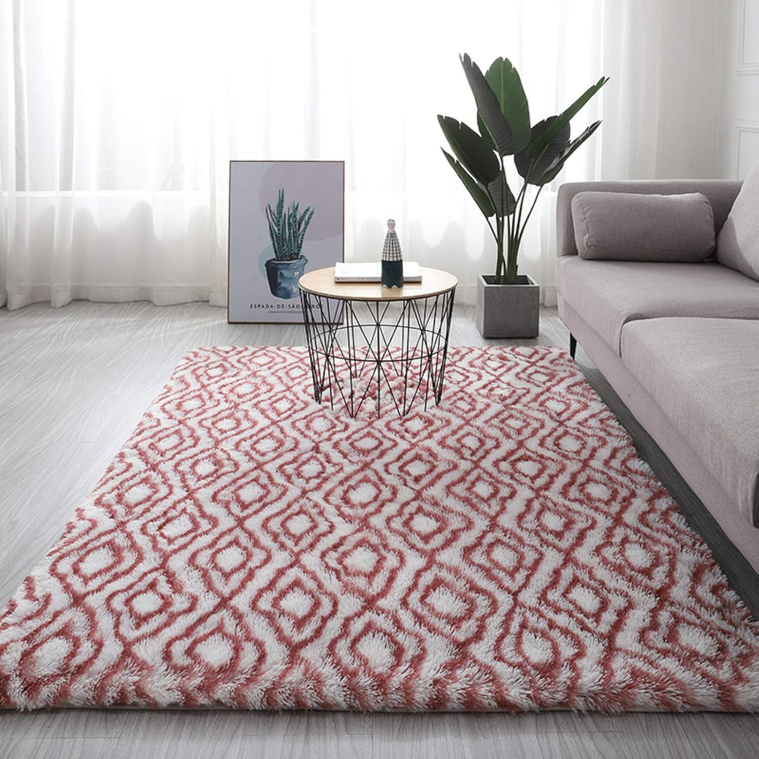 VibeCore Plush Patterned Area Rug in red design on a white background, featuring a soft polyester fiber texture and non-slip backing. Adds a cozy and vibrant touch to any room. Easy to clean and available in 5 stylish options.
