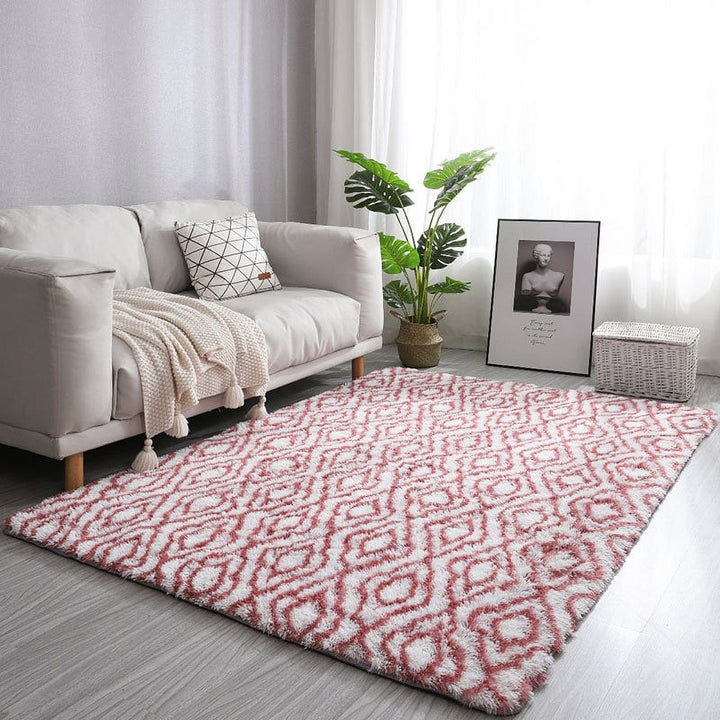 VibeCore Plush Patterned Area Rug in red design on a white background, placed in a living room, featuring a soft polyester fiber texture and non-slip backing. Adds a cozy and vibrant touch to your space. Easy to clean and available in 5 stylish options.