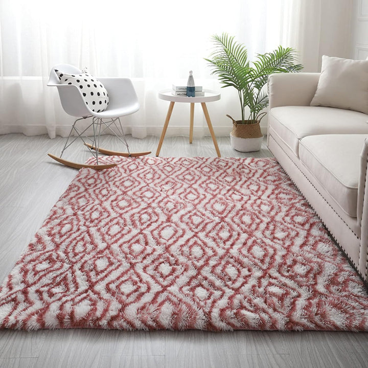 VibeCore Plush Patterned Area Rug in red design on a white background, placed on the living room floor, featuring a soft polyester fiber texture and non-slip backing. Adds a cozy and vibrant touch to your space. Easy to clean and available in 5 stylish options.