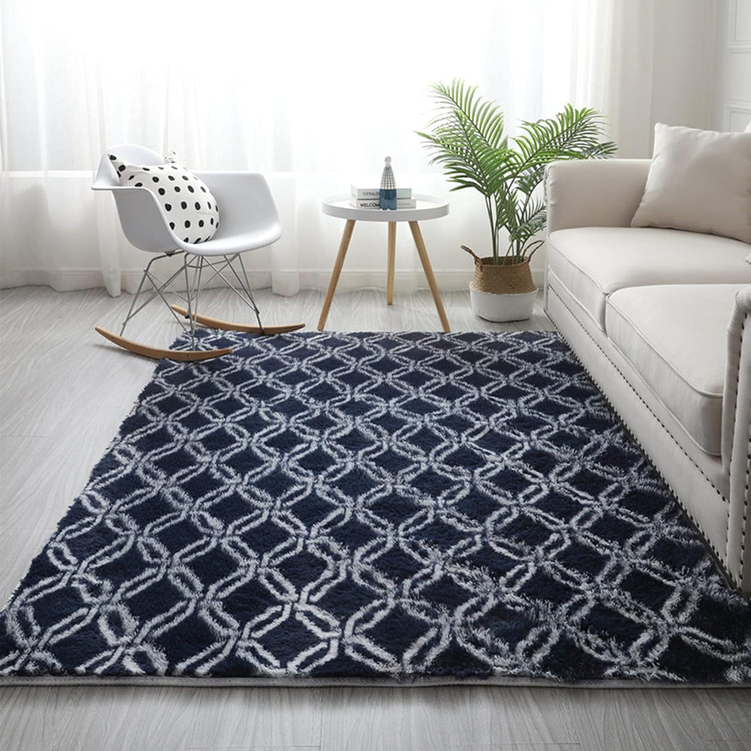 VibeCore Plush Patterned Area Rug in white design on a blue background, featuring a soft polyester fiber texture and non-slip backing. Adds a cozy and stylish touch to any room. Easy to clean and available in 5 stylish options.