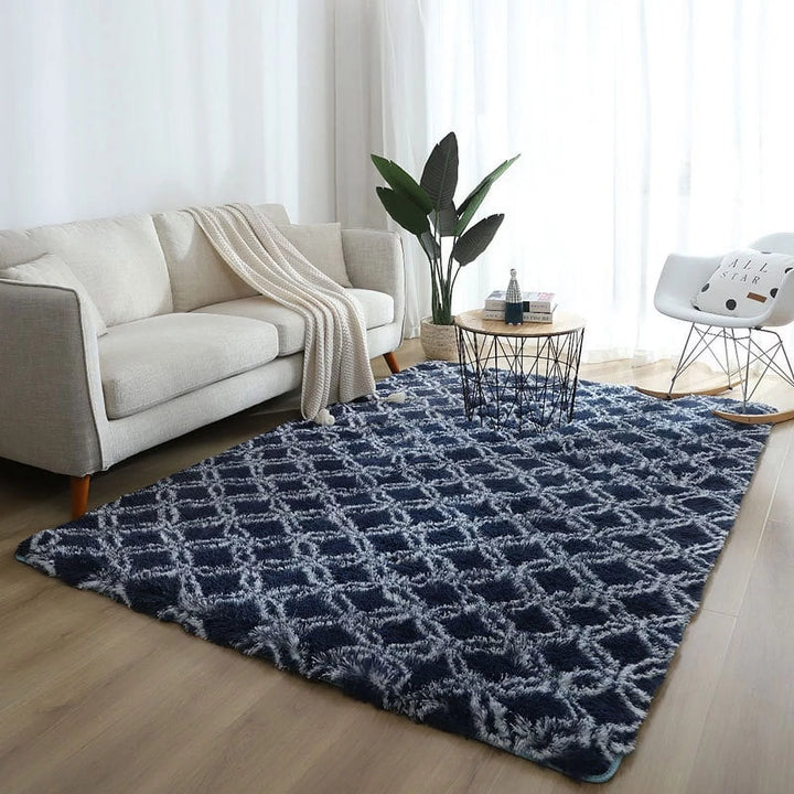 VibeCore Plush Patterned Area Rug in white design on a blue background, placed in a living room, featuring a soft polyester fiber texture and non-slip backing. Adds comfort and style to your space. Easy to clean and available in 5 stylish options.