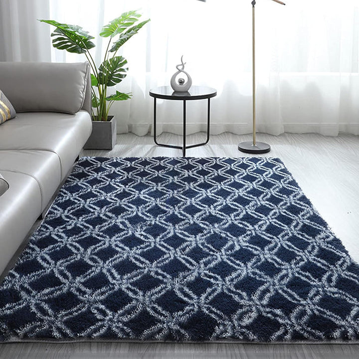 VibeCore Plush Patterned Area Rug in white design on a blue background, placed on the living room floor, featuring a soft polyester fiber texture and non-slip backing. Adds a stylish and cozy touch to your space. Easy to clean and available in 5 stylish options.