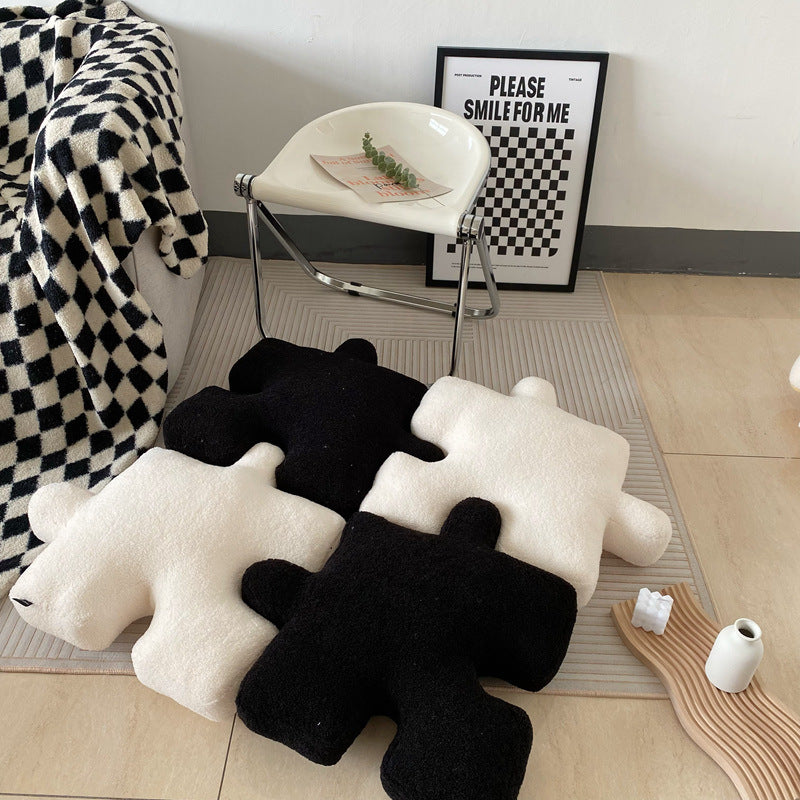 VibeCore Puzzle Piece Decorative Pillow in black and white, pieced together to showcase its quirky, playful design. Made from plush fabric and filled with PP cotton for cozy comfort, this unique pillow adds a fun, bold touch to your bed, couch, or cozy nook.