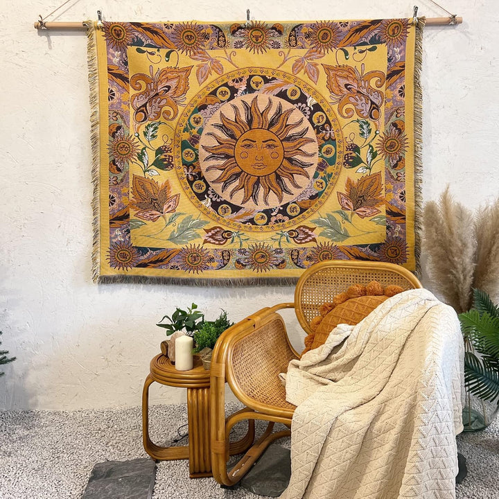 VibeCore Radiant Sun Woven Blanket as a wall hanging, showcasing vibrant boho-sun design and soft 100% combed cotton texture.