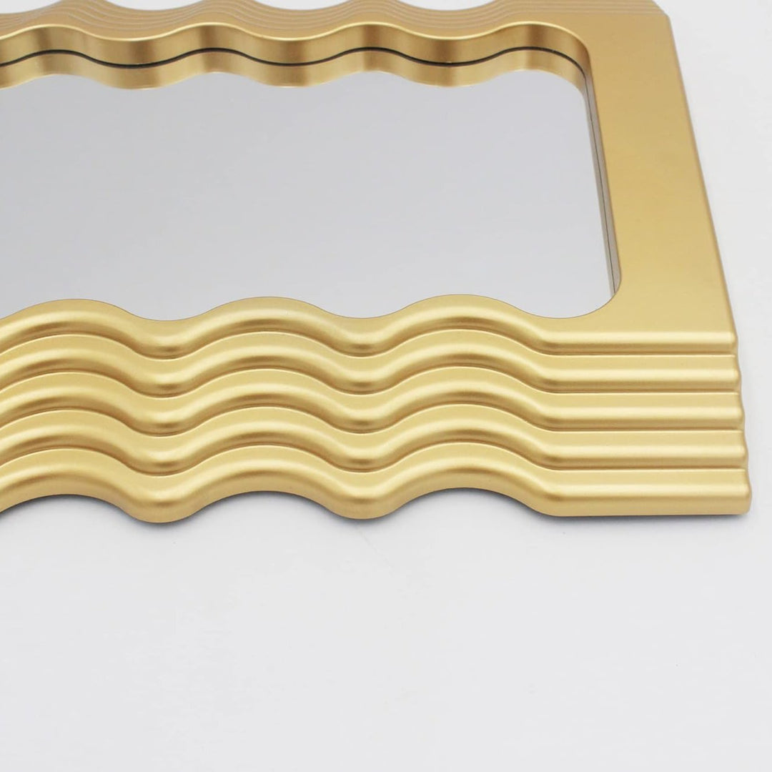 Close-up of the VibeCore Retro Wave Mirror in gold, showcasing the unique ridge detailing along the frame, offering a refined, textured accent to its sleek, wave-inspired design.