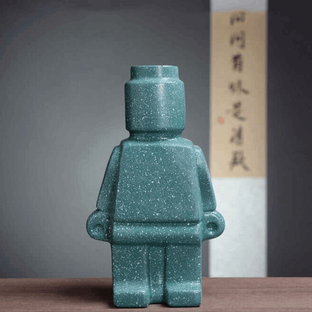 Aesthetic robot vase in turquoise featuring a sleek minimalist design with pop-culture influence perfect for adding a bold artistic touch to shelves tables or modern home decor.