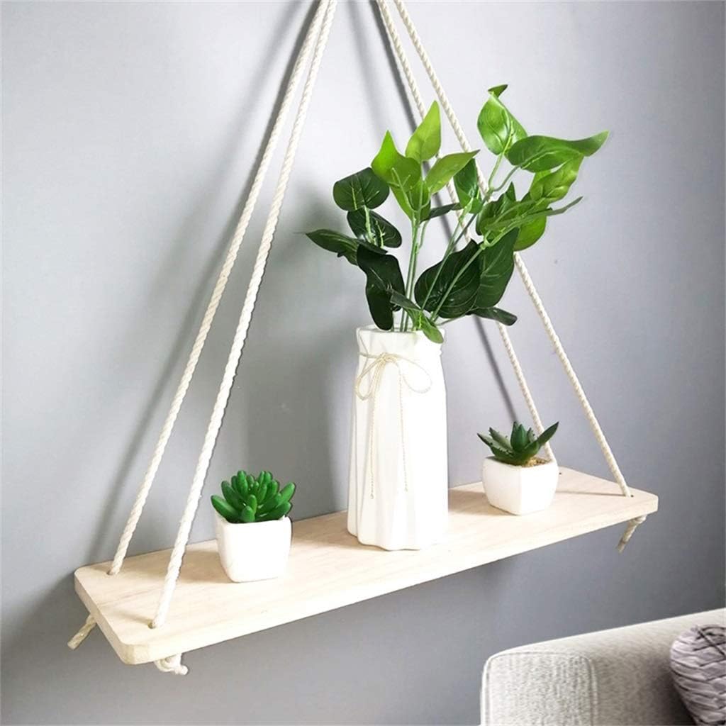 VibeCore Rope Hanging Shelf in a cozy living room, showcasing its rustic paulownia wood and sturdy rope design, perfect for displaying plants, candles, or decor.