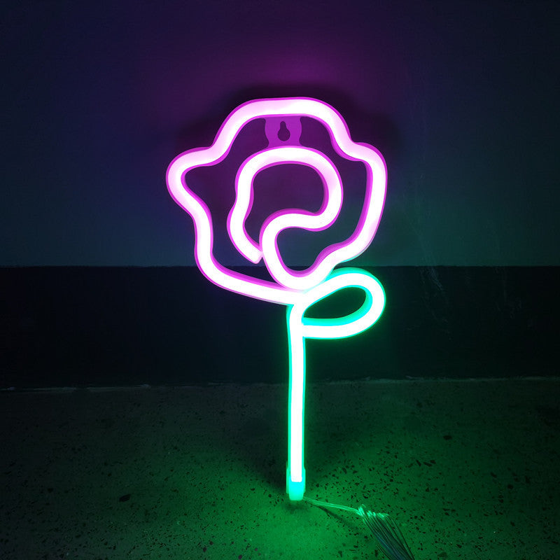 VibeCore Rose Neon Light in pink, casting a soft, romantic glow in any space, ideal for bedrooms or lounges.