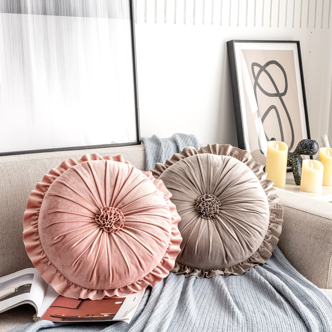 VibeCore Round Tufted Flower Throw Pillow on a couch, featuring elegant ruffled Dutch velvet petals in a vibrant color, adding a modern and luxurious touch to the living room decor.