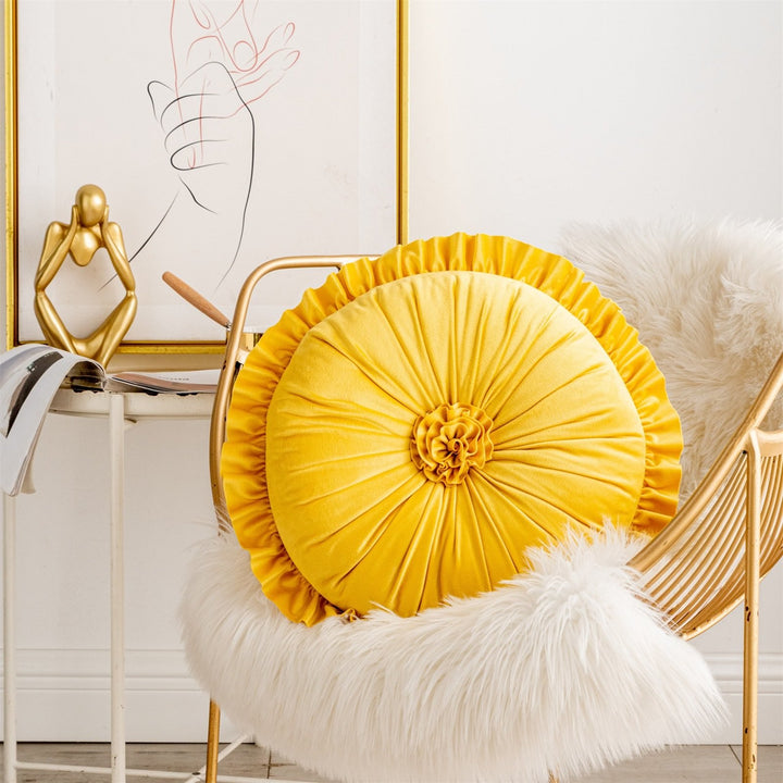 VibeCore Round Tufted Flower Throw Pillow in yellow placed on a chair, featuring a ruffled flower design for a bright, stylish, and cozy touch to your living space.