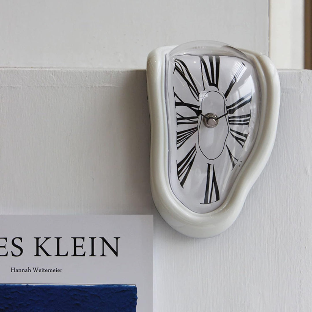 VibeCore Salvador Dali's Melting Clock in White, captured in a close-up on a fireplace, blending surrealist art with functional timekeeping for a unique, striking decor piece.