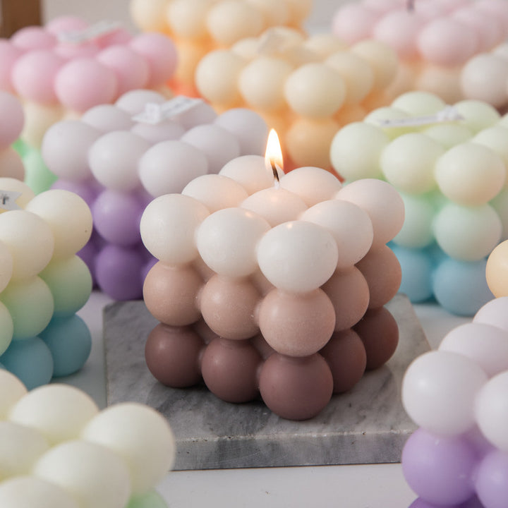 Scented Gradient Bubble Cube Candle Brown lit among other vibrant gradient colors