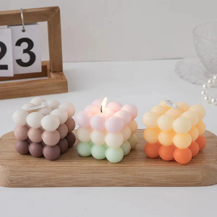 Scented Gradient Bubble Cube Candle in brown, pastel green, and orange
