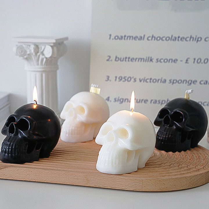 All four scented skull candles in rose, mauve, white, and black, featuring bold, striking designs and captivating fragrances, perfect for adding an edgy and unique touch to your room decor.