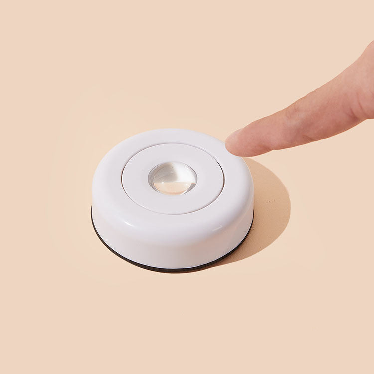 Close-up of VibeCore Sunset Puck Light in white, showing its sleek, compact design and touch-activated functionality.
