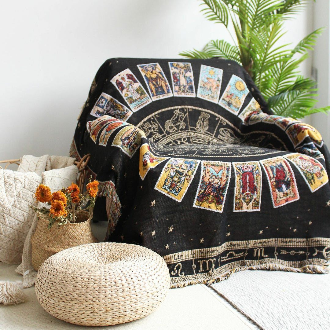 VibeCore Tarot Card Mandala Woven Blanket draped over chair, featuring a spiritual-inspired design with intricate mandalas and tarot card motifs. Made from soft, breathable 100% combed cotton, it adds a mystical, vibrant touch to any space.