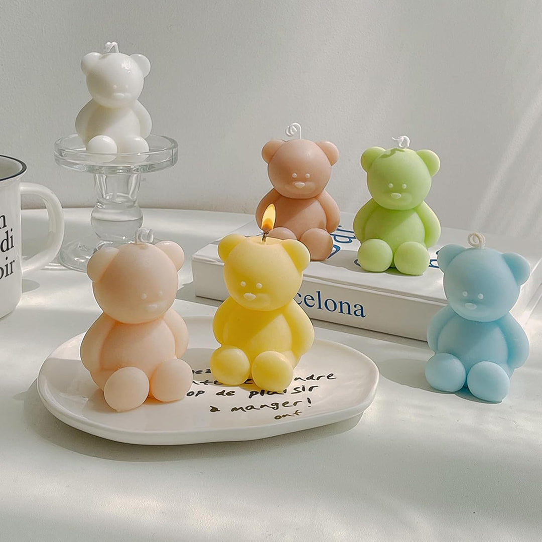 Collection of pastel teddy bear-shaped candles in white, light pink, sky blue, yellow, mauve, and green, adding a whimsical touch and soothing fragrances to any space.