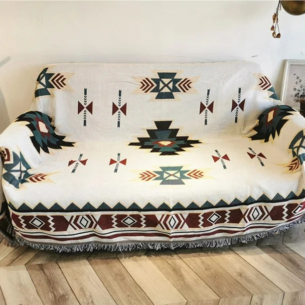 VibeCore Terra Medallion Woven Blanket draped over a couch, featuring its earthy medallion design and showcasing the vibrant, reversible patterns for a bohemian-inspired look.