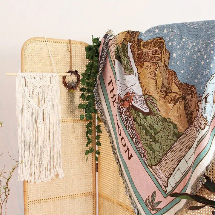 VibeCore The Moon Tarot Woven Blanket on wall divider, showcasing celestial-inspired design and soft 100% combed cotton texture.