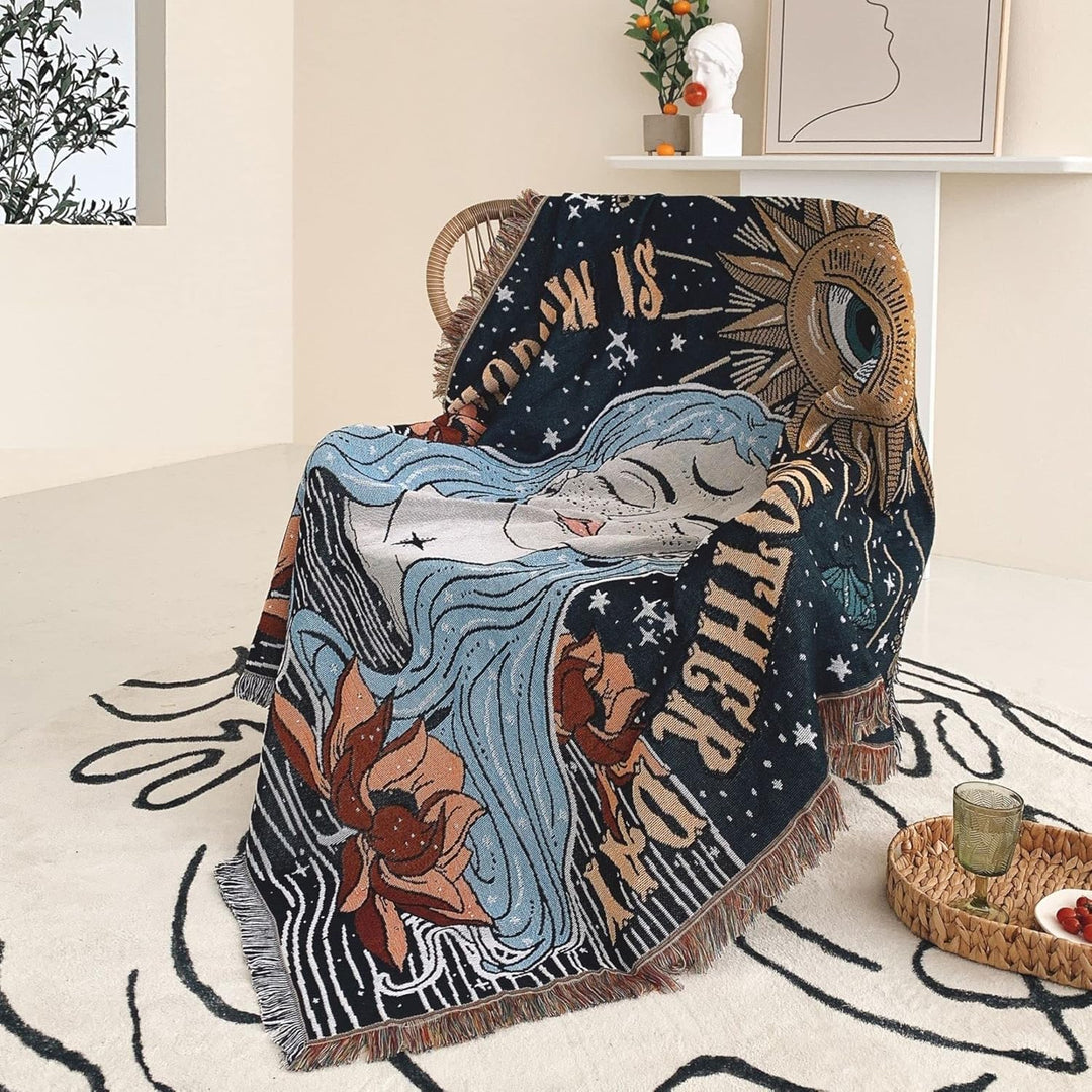 VibeCore Tomorrow Is Another Day Woven Blanket draped over a chair, highlighting its spiritual-inspired design and reversible patterns for a cozy, artistic accent.