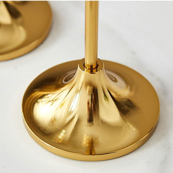 VibeCore Vintage Golden Candle Holder base close up, crafted from high-quality iron and brass with a sleek golden finish, highlighting its sturdy, heavy round base designed for stability and elegance in any setting.