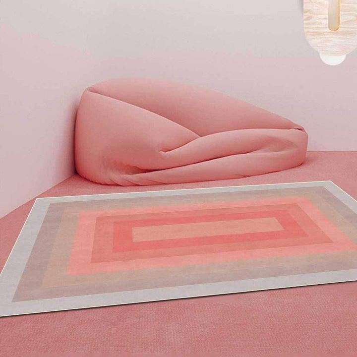 VibeCore Watercolor Gradient Area Rug Coral Pink on a pink floor, featuring a soft gradient design of coral pink hues that blend seamlessly into the surrounding space, adding a warm, artistic touch.