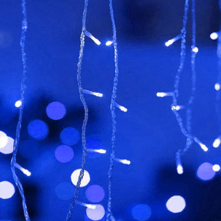 Close-up of VibeCore waterfall string lights in blue, glowing with a soft, calming light for a serene, cozy ambiance.
