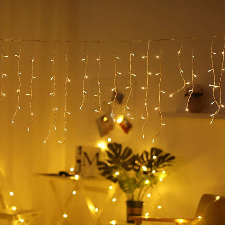 VibeCore waterfall string lights in warm white, hanging gracefully to create a cozy, ambient glow in any space.