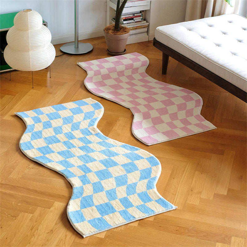 Aesthetic "Wavy Checkerboard Accent Rug" in pink and blue, featuring a dynamic checkerboard pattern with a wavy twist. This soft, plush rug showcases its non-slip backing, making it perfect for adding style and comfort to bedrooms, dorms, or living spaces.