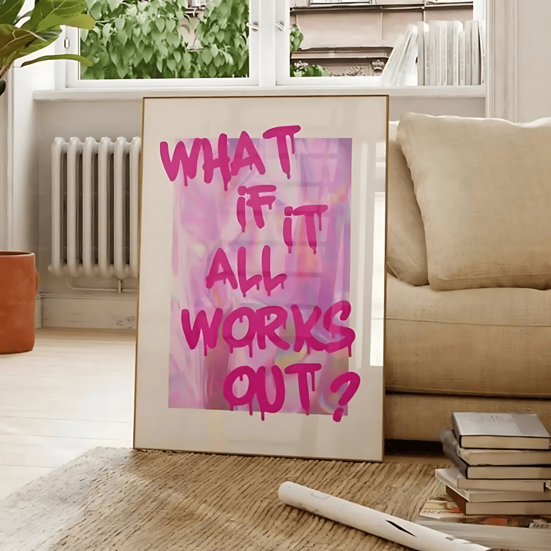 VibeCore 'What If It All Works Out' Canvas Poster against a couch, featuring a preppy, graffiti-inspired design in pink. This playful, contemporary print brings a fun, girly touch to any space, adding personality to your living room, bedroom, or dorm. Printed on durable cotton canvas with a semigloss finish, it maintains vibrant colors and lasting style.