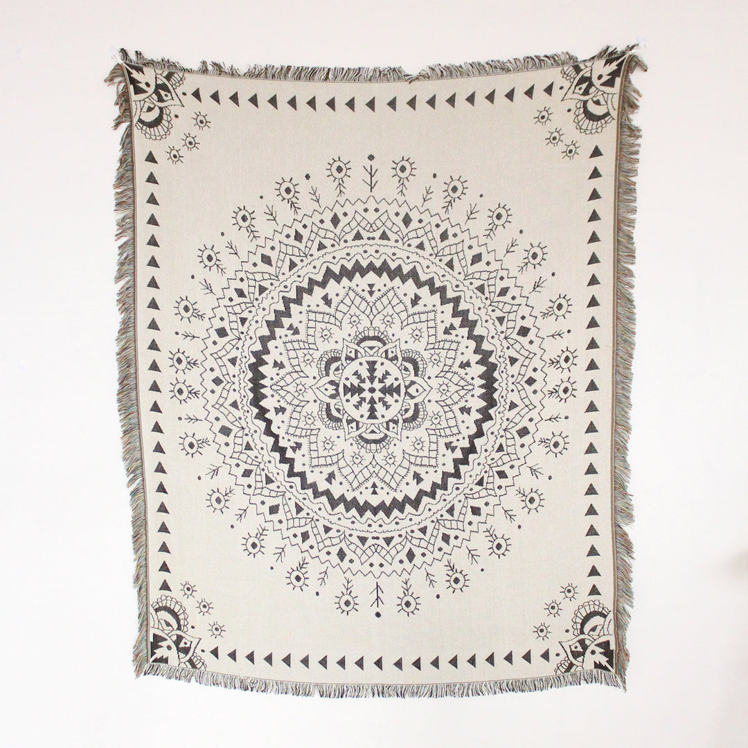 VibeCore White Boho Mandala Woven Blanket product view, showcasing a calming boho mandala design. Crafted from soft, breathable 100% combed cotton, this versatile blanket features reversible patterns and adds vibrant, bohemian style to any room.