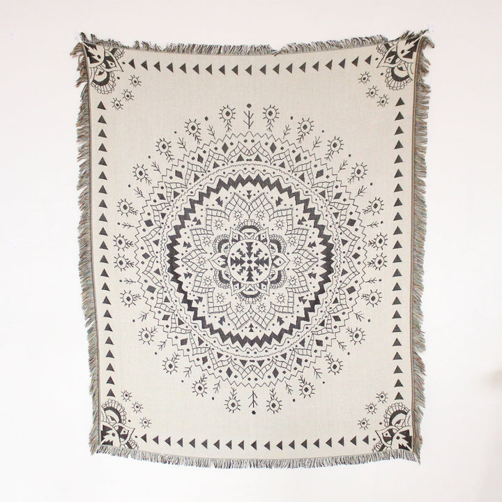 VibeCore White Boho Mandala Woven Blanket product view, showcasing a calming boho mandala design. Crafted from soft, breathable 100% combed cotton, this versatile blanket features reversible patterns and adds vibrant, bohemian style to any room.