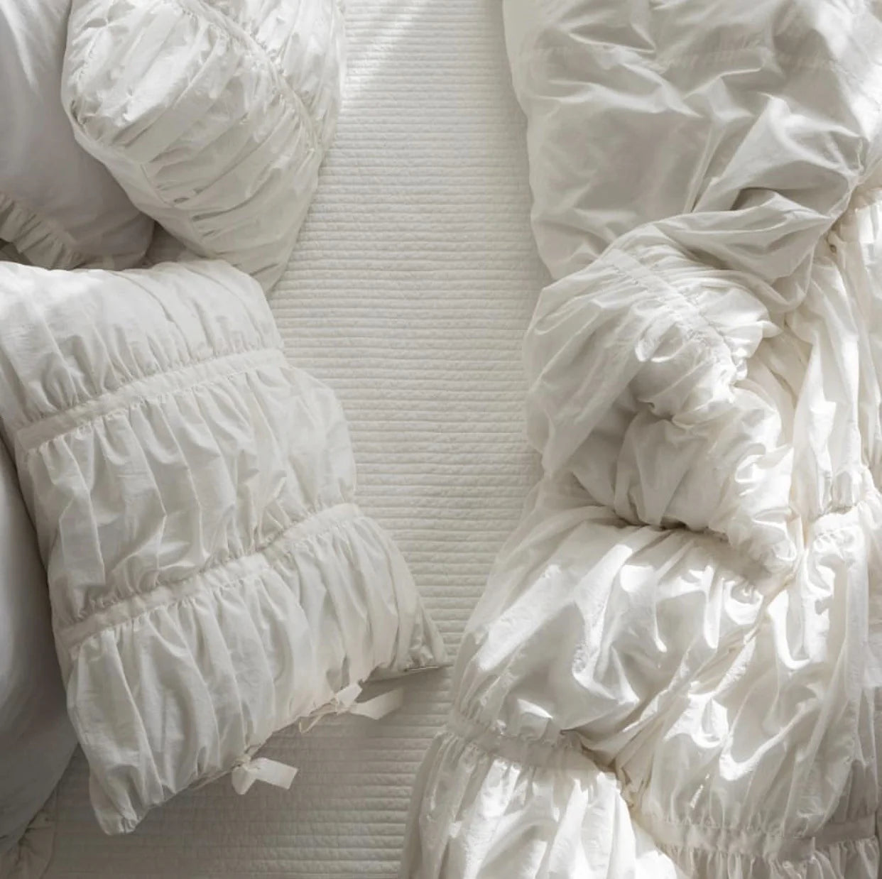 Close-up top view of VibeCore white ruched duvet cover set, textured tufted cotton fabric, aesthetic fleece duvet_cover set, soft breathable bedding, romantic coquette style, minimalist white decor, elegant luxury details, cozy bed inspiration, timeless cotton bedding, king or twin size.