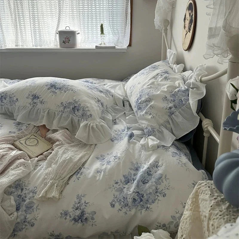 Bedroom with floral bedding and lace curtains