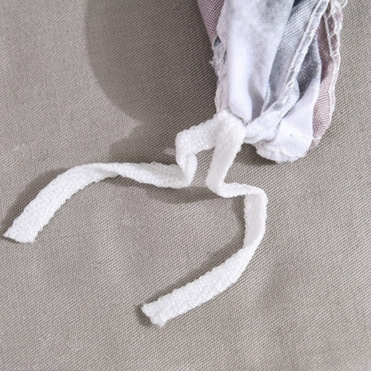 Close-up of the string end detail on the VibeCore Aesthetic Abstract Canvas Duvet Cover Set, showcasing the clean, secure finish. This detail adds a polished touch to the set while maintaining its modern and stylish aesthetic.