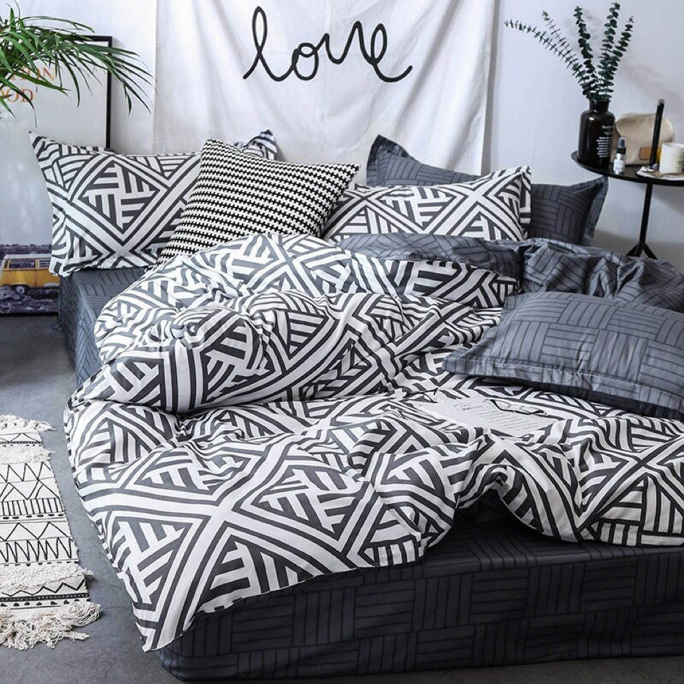 Front view of the VibeCore Aesthetic Aztec Geometric Duvet Cover Set in black and white, featuring bold Aztec-inspired geometric patterns. Crafted from a soft cotton-polyester blend, this duvet cover set brings modern elegance and comfort to any bedroom or dorm room.