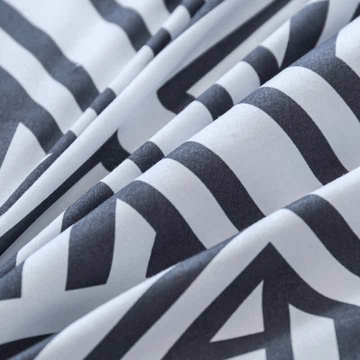 Close-up of the soft cotton-polyester blend material of the VibeCore Aesthetic Aztec Geometric Duvet Cover Set, showcasing its smooth texture and durability. The bold black and white Aztec geometric pattern adds modern style, offering both comfort and sophistication for any bedroom or dorm room.