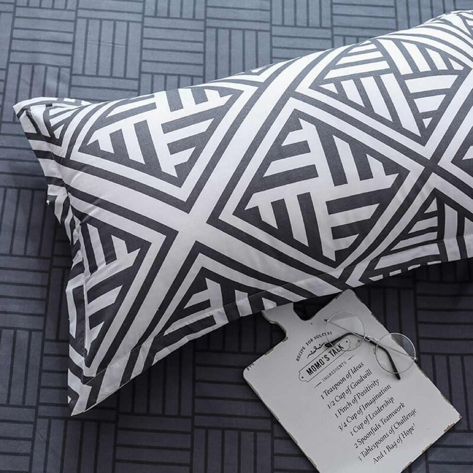 Close-up of the VibeCore Aesthetic Aztec Geometric Pillowcase, featuring bold black and white Aztec-inspired geometric patterns. Made from a soft cotton-polyester blend, this pillowcase complements the duvet cover set, adding modern style and comfort to your bedroom or dorm room.