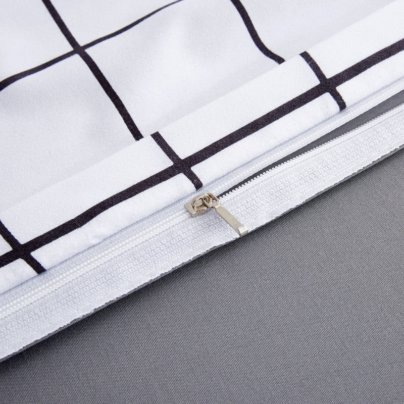 Close-up of the durable zipper closure on the VibeCore Black and White Grid Bedding Set, showcasing its sleek design and practicality. This high-quality feature ensures easy duvet insertion and a secure fit, complementing the bedding's minimalist black-and-white grid pattern and cozy cotton-polyester blend.