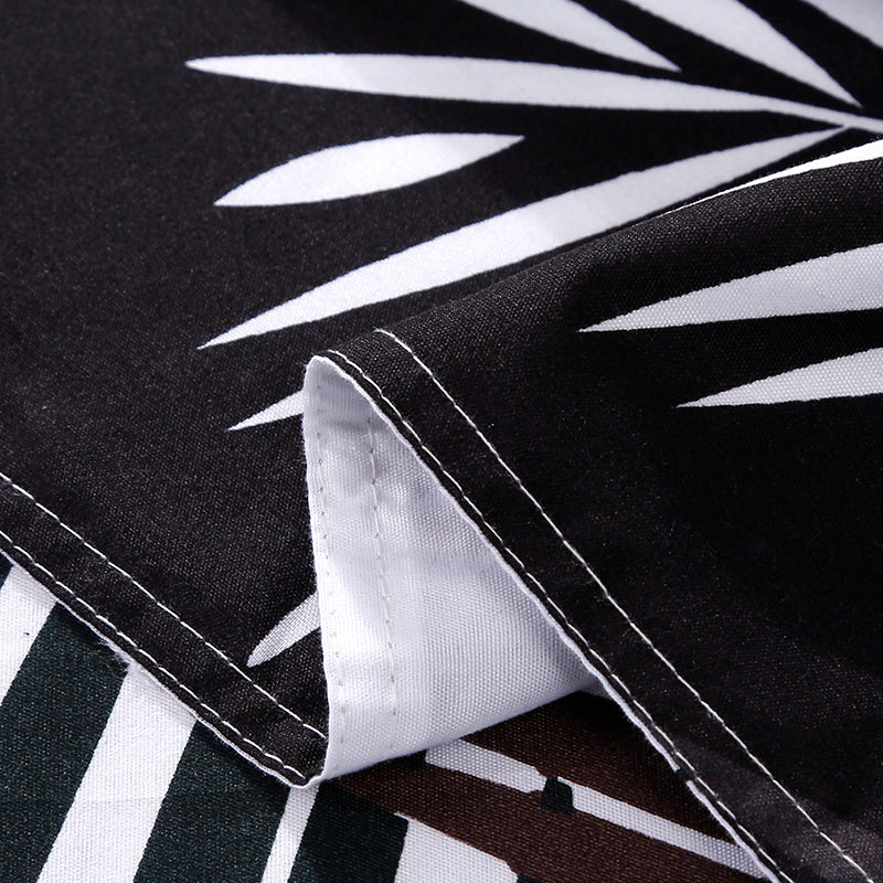 Close-up of the soft cotton-polyester blend material of the VibeCore Aesthetic Black Leaf Duvet Cover Set, highlighting its smooth texture and durability. The black and green leaf pattern adds a nature-inspired touch, offering both comfort and style for modern bedrooms or dorm rooms.